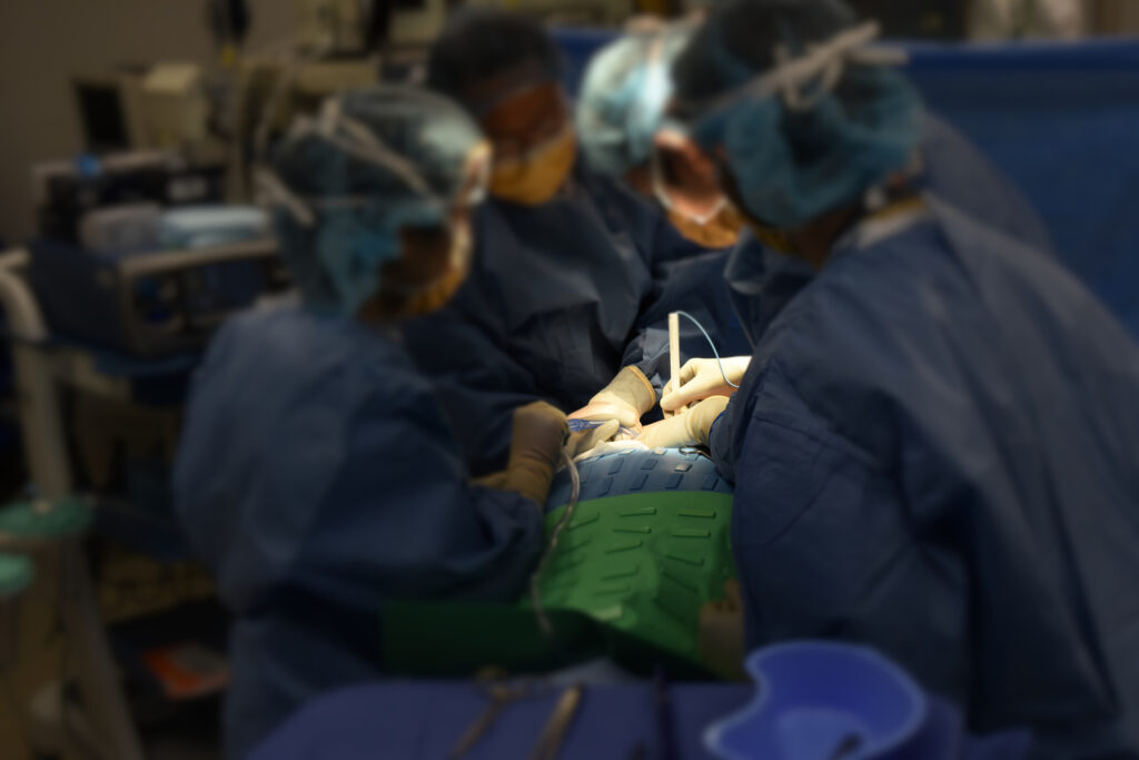 Surgeons operating on a patient.